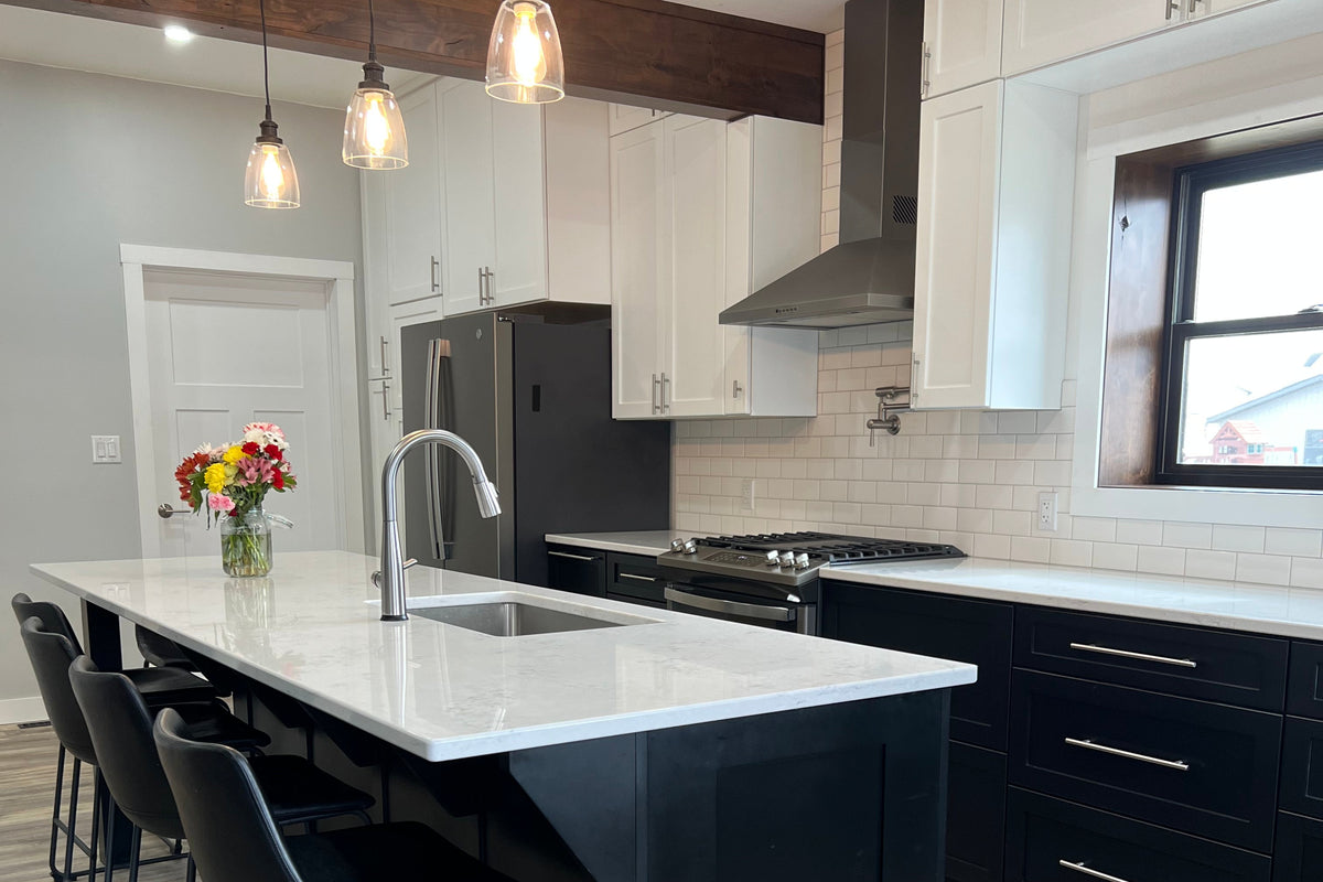 Modern kitchen with black island and white cabinets