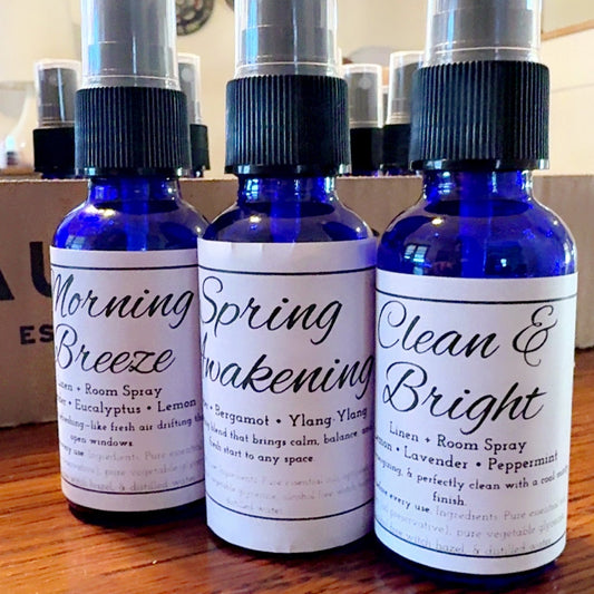 Three blue bottles with labels on a wooden surface