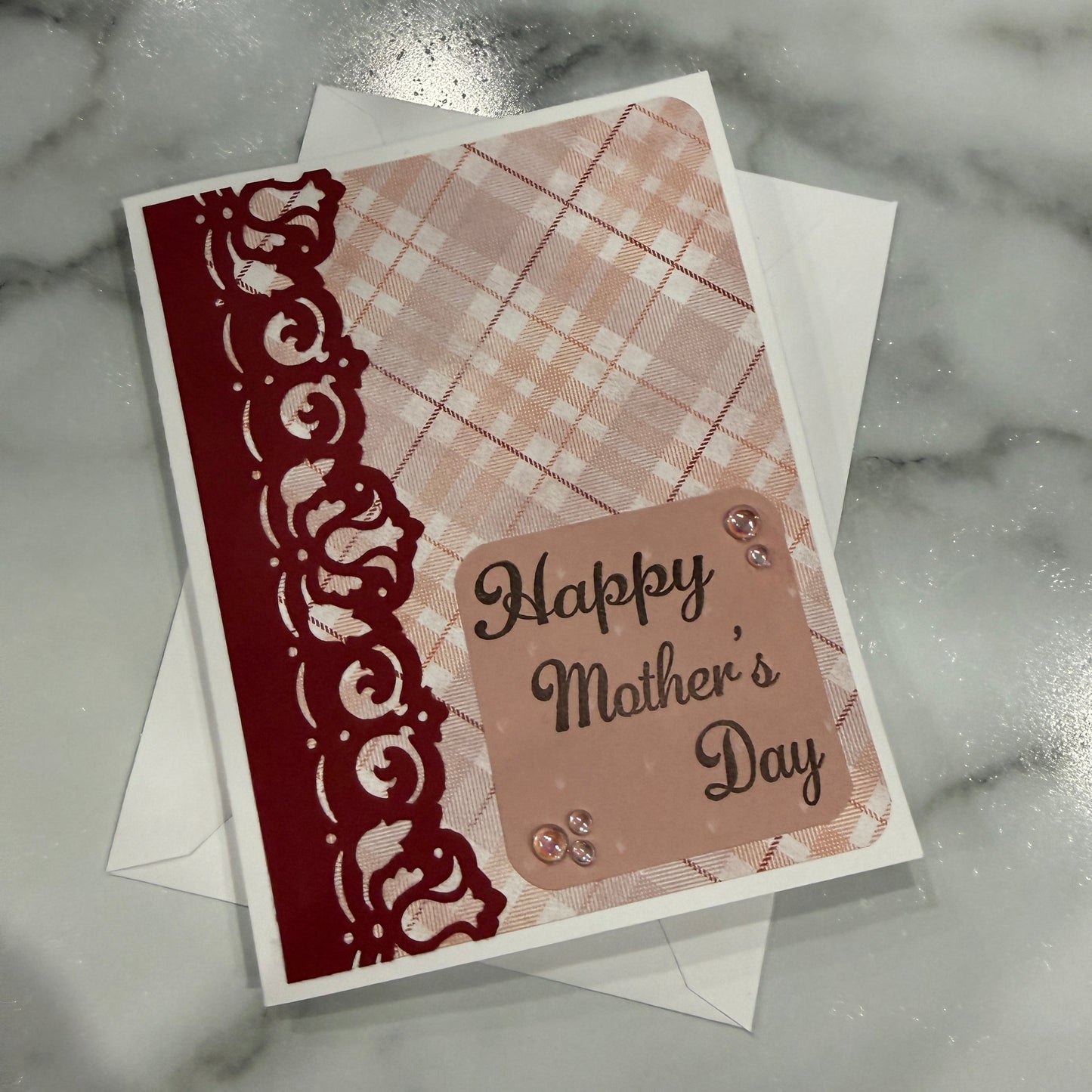 Greeting card with 'Happy Mother's Day' text on a textured surface