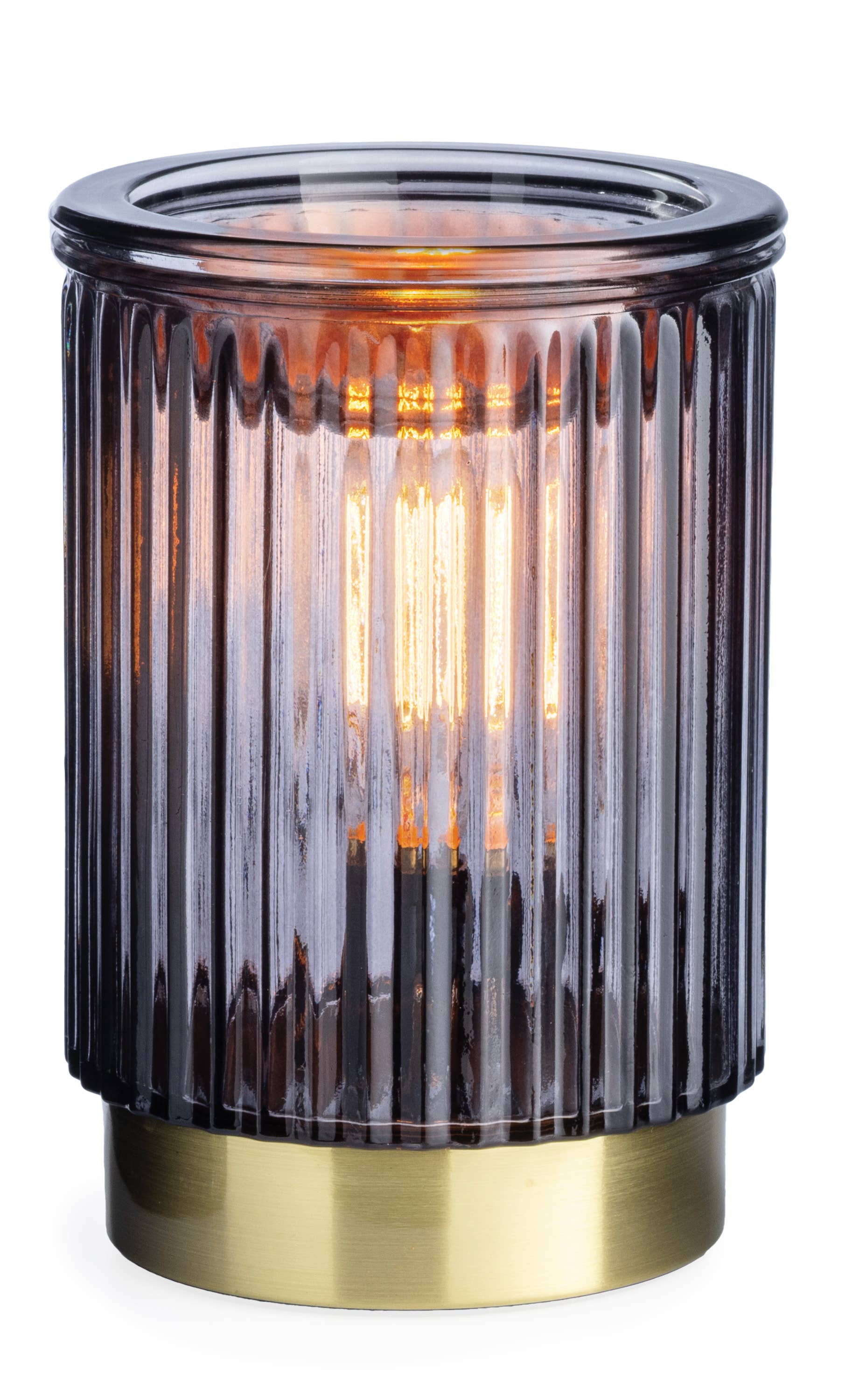 A modern table lamp with a ribbed translucent smoky purple glass shade and a brushed brass base, illuminated with a warm orange glow.
