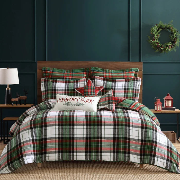Spencer Plaid Flannel Comforter Set by Levtex Home in green, red, white and charcoal plaid, styled on a Christmas bed with festive pillows.