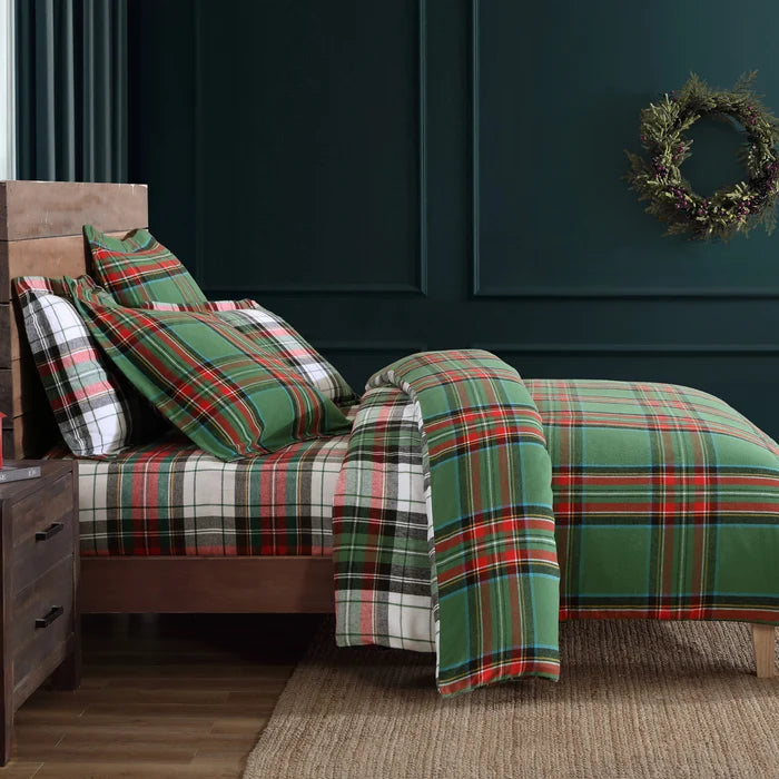 Side view of the reversible Spencer Plaid Flannel Comforter Set showing green tartan plaid and white plaid patterns in a holiday bedroom.
