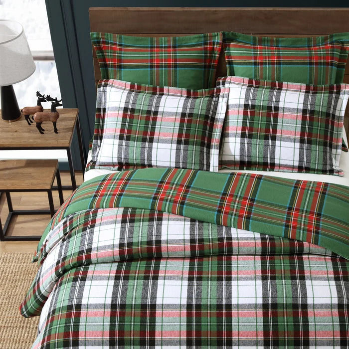 Close-up of Spencer Plaid Flannel Comforter Set featuring white, green, charcoal and red plaid with coordinating green plaid pillow shams.