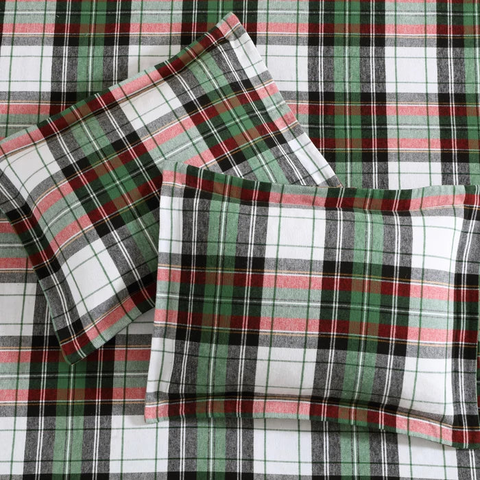 Detailed view of Spencer Plaid Flannel Comforter Set showing soft white, green, red and charcoal tartan fabric with matching shams.