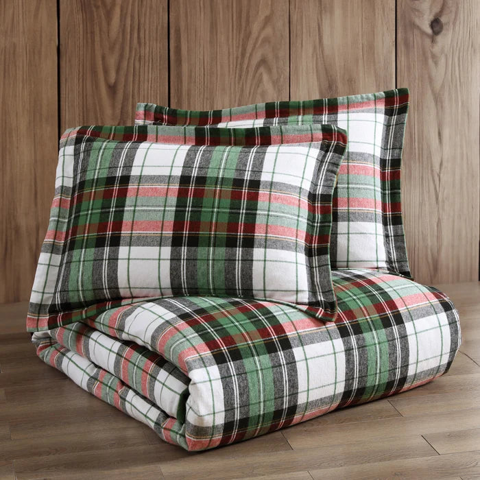 Folded Spencer Plaid Flannel Comforter Set with two coordinating plaid pillow shams displayed against a natural wood background.
