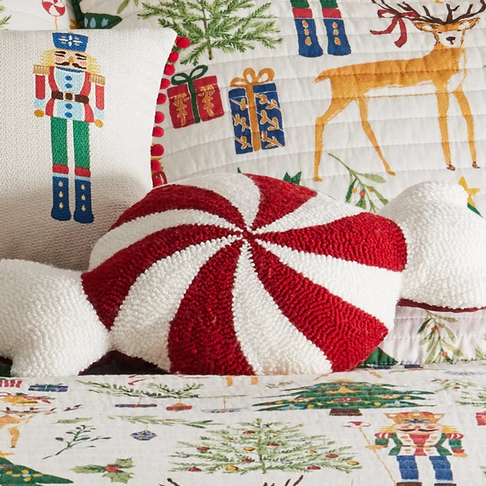 Peppermint Candy Shaped Pillow in red and white displayed on festive Nutcracker Christmas bedding with embroidered holiday accent pillows.