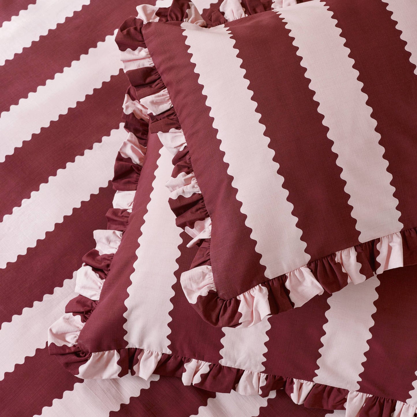Close-up of burgundy and blossom striped fabric with ruffled edges