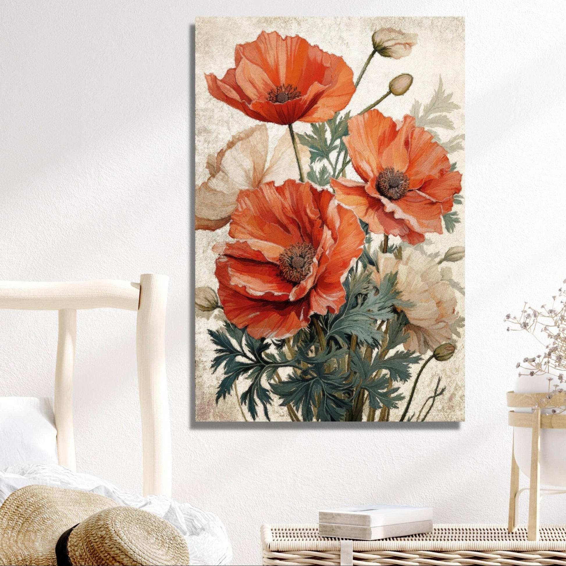 Floral painting on a wall above a wicker table with a hat and books, next to a bed.